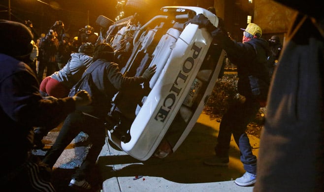Protesters flip over a Ferguson police car in Ferguson, Missouri, Nov. 25.  Jim Young / Reuters