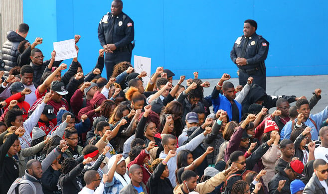 Law enforcement officers watching as college students in Atlanta protest the decision not to indict the officer. Curtis Compton / Atlanta Journal-Constitution / AP