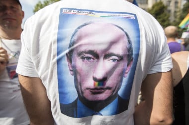 A demonstrator walks down Kurfuerstendamm and protests against Russia's new anti-gay propaganda law with a T-shirt of Russian President Vladimir Putin reading 'Stop Homophobia!' in Berlin, Germany, 31 August 2013. Several thousand people attended the demonstration under the motto 'Enough is Enough - Stop Homophobia', which lead from Kurfurstendamm to the Russian embassy.  EPA/FLORIAN SCHUH