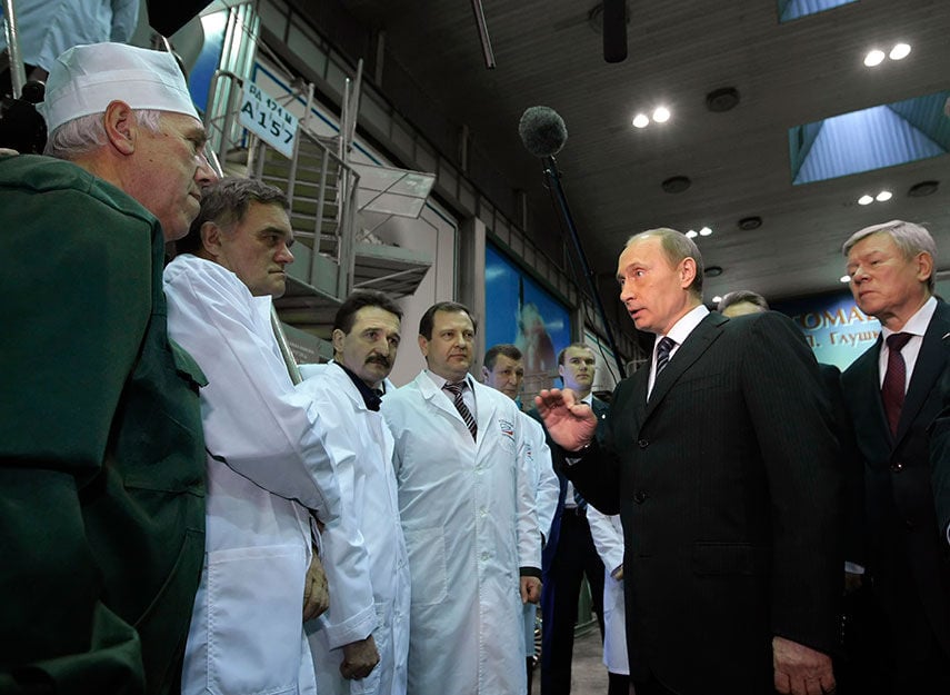 IN HIS ORBIT: President Vladimir Putin takes a close interest in Russia’s space companies. Here, as prime minister in 2009, he talks to staff at Energomash, maker of the RD-180 engines that power U.S. Atlas V rockets. REUTERS/Ria Novosti/Pool/Alexei Nikolsky