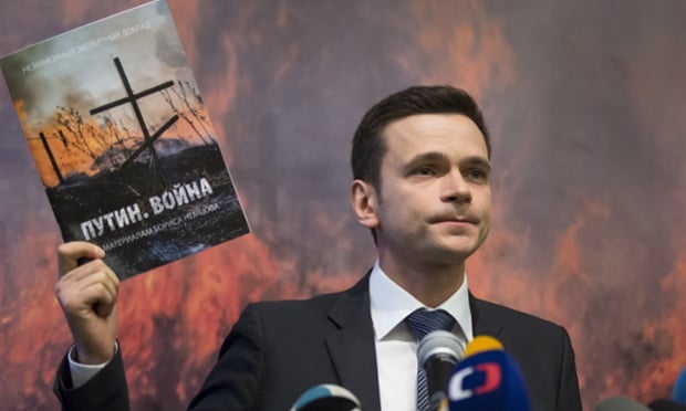 Russian opposition figure Ilya Yashin holding a report by slain Russian opposition leader Boris Nemtsov speaks to the media in Moscow, Russia, Tuesday, May 12, 2015. A report released Tuesday containing material compiled by slain Russian opposition leader Boris Nemtsov said at least 220 Russian soldiers died in two battles in eastern Ukraine within the past year. (AP Photo/Alexander Zemlianichenko)