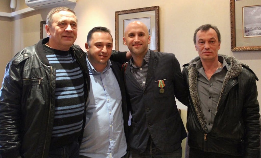 Graham Phillips wearing medal (right centre) stood between Pavel Hlyupin (far right) and Pavel Semchuck.