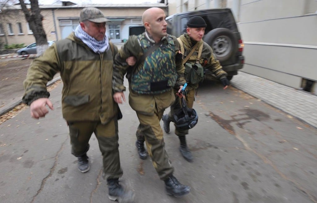 Graham Phillips (center) escorted by Russia's DNR soldiers after being wounded in Ukraine on Nov 24th 2014