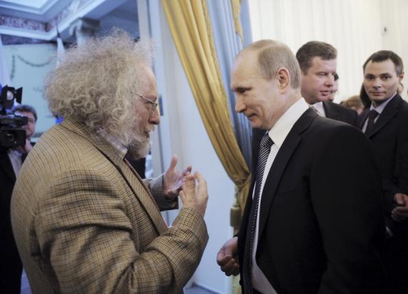 Russian current Prime Minister Vladimir Putin speaks with Alexei Venediktov (L), editor in chief of the "Ekho Moskvy" (Echo of Moscow) radio station, after a state awards ceremony for achievements in printed media in Moscow, Russia, in this January 13, 2011 file photo. REUTERS/Yana Lapikova/RIA Novosti/Pool/Files