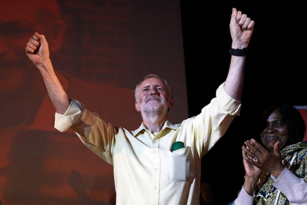 LONDON, ENGLAND - AUGUST 03: Jeremy Corbyn raises his arms in the air after speaking to supporters at a Labour party leadership rally on August 3, 2015 in London, England. Campaigning for Labour party leadership is continuing by all candidates with polls putting Jeremy Corbyn currently in the lead. Voting is due to begin on the 14th August and will close on the 10th September, with the results being announced on the 12th September. (Photo by Carl Court/Getty Images)