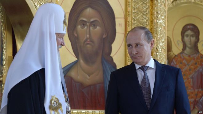 Russian TV viewers are well used to seeing President Putin (right) at Orthodox Church ceremonies