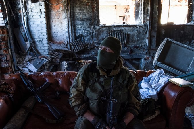  A Russia-backed rebel in eastern Ukraine on Tuesday. Russia has used “hybrid war” tactics to mask its operations there. Credit Mstyslav Chernov/Associated Press 