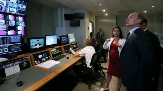 Russian President Vladimir Putin was given a tour of Russia Today's Moscow HQ by Editor-in-Chief Margarita Simonyan (centre) in 2013 / AP