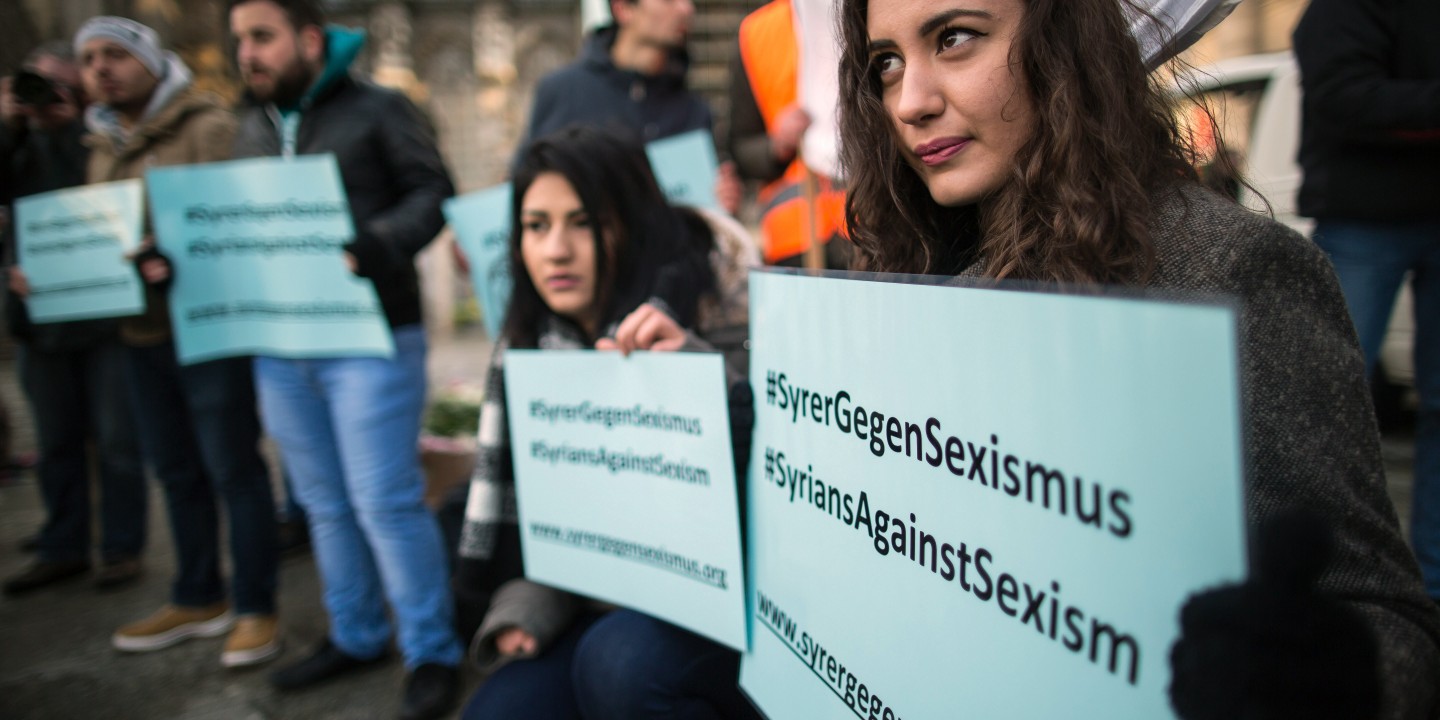 A woman from Syria protests during the demonstration 'Syrian refugees say no to the Cologne assaults!' in Cologne, Germany, 16 January 2016. According to police reports, numerous women were sexually harassed and robbed in the throng in front of Cologne central station on New Year's Eve