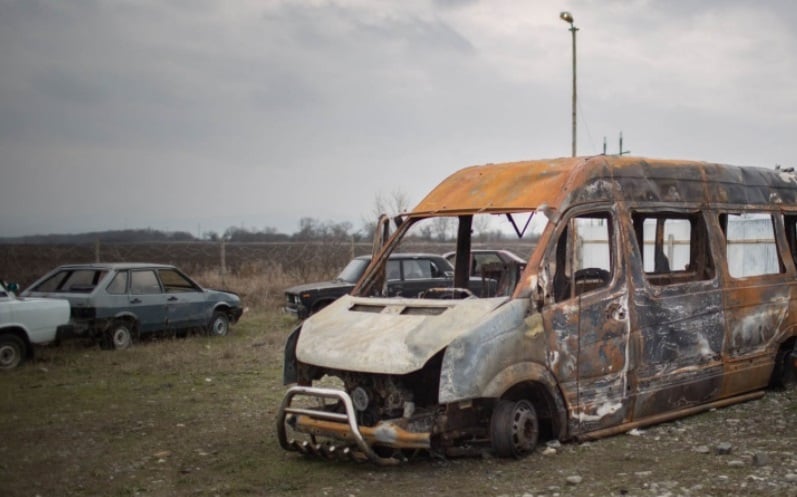The burn-out frame of a minivan in which journalists and rights activists were traveling near the Chechen border when they were attacked March 9, 2016. Photo by Denis Sinyakov/MediaZone