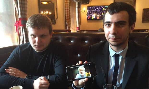 Alexei Stolyarov, left, and Vladimir Kuznetsov in Moscow show video of their prank on Ukrainian oligarch Ihor Kolomoisky. Photograph: The Guardian 