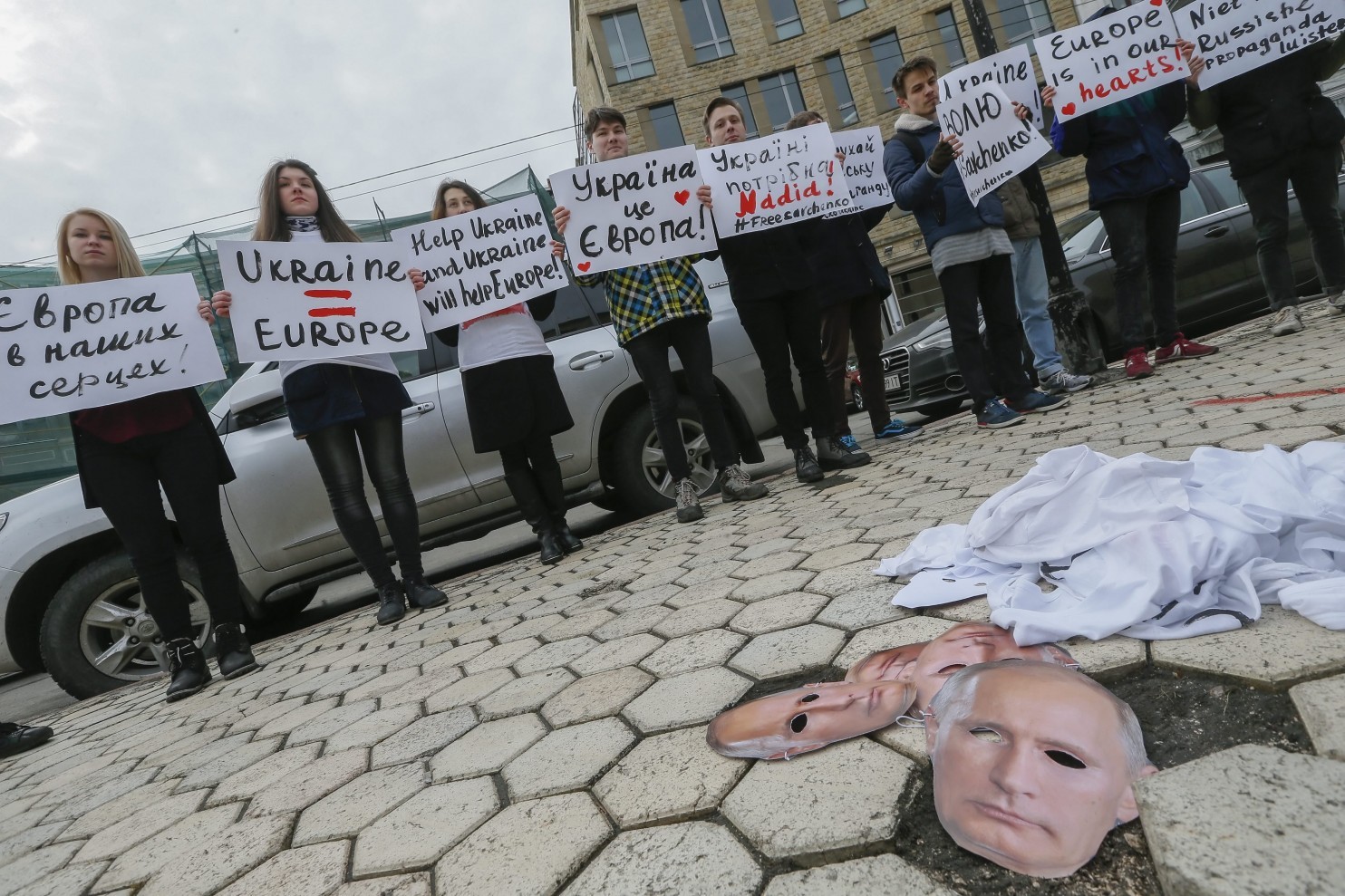 Ukrainian activists hold placards in front of masks depicting Russian President Vladimir Putin during a rally near the Dutch embassy in Kiev ahead of a Dutch referendum on a European Union trade agreement with Ukraine. The signs read “Don't listen to Russian propaganda,” “Ukraine is Europe” and ‘”elp Ukraine and Ukraine will help Europe.” (Sergey Dolzhenko/EUROPEAN PRESSPHOTO AGENCY)