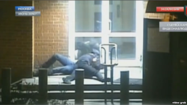 The video, broadcast by Gazprom subsidiary NTV, shows a uniformed man spring from a guard station and tackle the diplomat after the latter exits a taxi and heads toward the embassy door