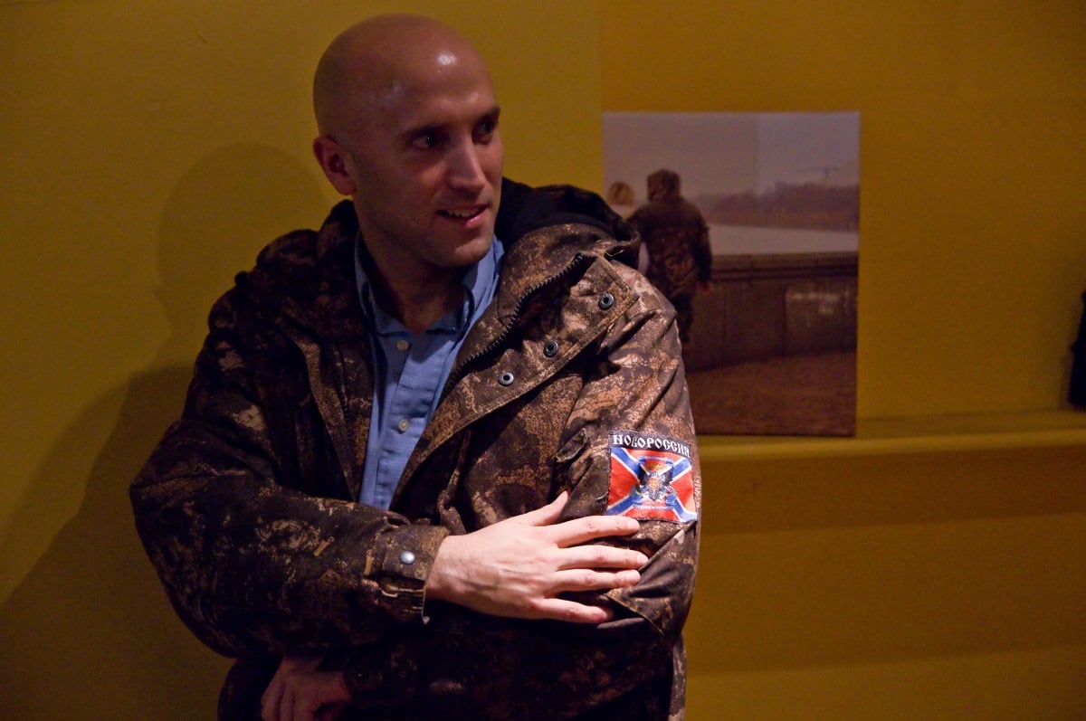 Phillips posing for a photo wearing a pro-separatist jacket at what he calls a charity event for militant-held territories (GettyImages Photo) 