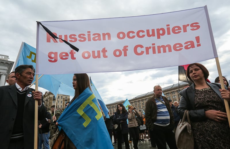 People hold a poster as they attend a rally to commemorate 72 years since Crimean Tatar deportation on Maidan Nezalezhnosti in Kyiv on May 18. (Volodymyr Petrov) 